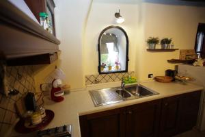 a kitchen counter with a sink and a mirror at La Casetta sul Lago in Castel Gandolfo