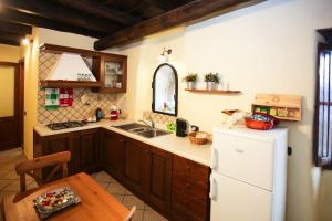 a kitchen with a white refrigerator and a table at La Casetta sul Lago in Castel Gandolfo