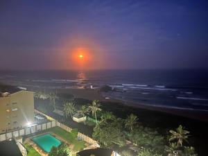 a view of the ocean from a hotel at night at Stella Maris Flat 93 Amanzimtoti in Amanzimtoti