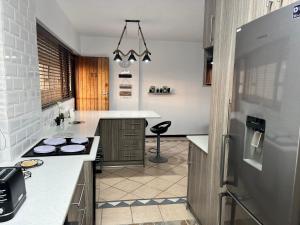 a kitchen with a counter and a stove in it at Stella Maris Flat 93 Amanzimtoti in Amanzimtoti