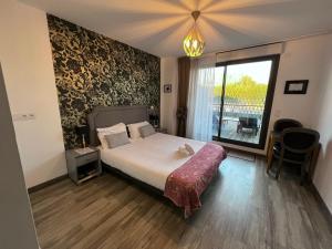 a bedroom with a bed and a large window at Les Terrasses D'Aix - Studio avec Grande Terrasse privée in Aix-en-Provence