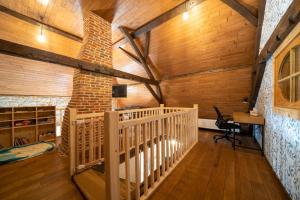 a room with wooden walls and a staircase in a cabin at La Ferme du Ravet - Gîtes aux Lacs de l'Eau d'Heure in Froid-Chapelle