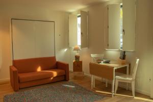 a living room with a couch and a table at Casa da Carvoaria in Vila Real
