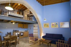 a living room with a blue couch and a table at Evkarpos Country House in Psematismenos