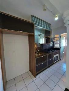 a kitchen with a counter and a large kitchen at Rap House in Nova Iguaçu