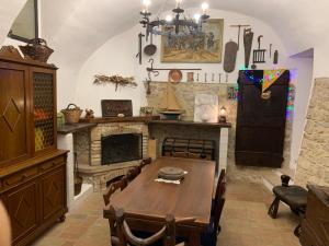 a dining room with a table and a fireplace at Il Carpino luxury historic apartment in Carpineto Romano
