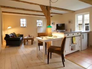 a kitchen and living room with a table and a couch at Holiday apartment Trulich Hoff 