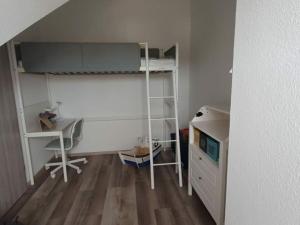 a small room with a desk and a bunk bed at Holiday apartment Hajos Koje in Schönberger Strand