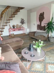 a living room with a couch and a table at Casa Diego Bielefeld mit Garten in Bielefeld