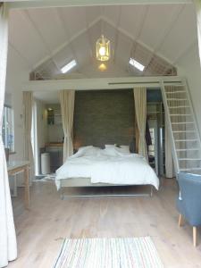 a bedroom with a large white bed in a room at B&B BLoom in Amsterdam