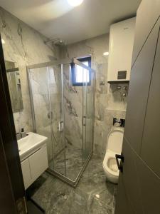 a bathroom with a shower and a toilet at Jutarnja Zvezda Kop in Kopaonik +11 photos