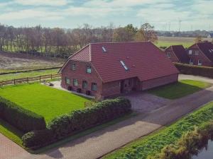 an aerial view of a house with a red roof at Holiday apartment Ponywiese in Ihlow