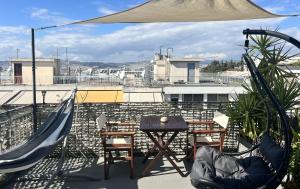 a patio with a table and a playground on a roof at Olympus! Athens! Studio in the Sky!! 20' walk to the Acropolis in Athens
