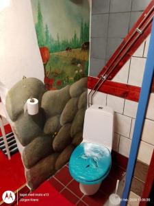 łazienka z toaletą z obrazem na ścianie w obiekcie Konstnären Lenas hus. w mieście Bockara