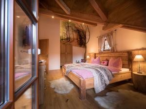 una camera da letto con letto e cuscini rosa di Carl-Lambrecht-Chalet No 19 a Ilsenburg