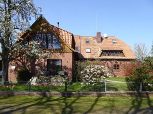 a house with a fence in front of it at Ausliche Adendorf in Adendorf