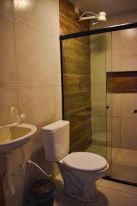 a bathroom with a toilet and a sink and a shower at Caminho do Paraíso in Porto De Galinhas