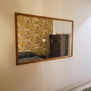 a mirror hanging on a wall in a room at La Casetta di Oppi in Naples