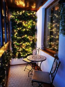 a christmas tree on a balcony with a table and chairs at Apartment Pamporovo Palaсe A75 in Pamporovo