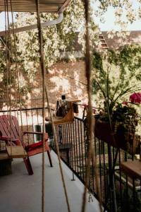 a porch with a swing and chairs on a patio at Irresistible 2 bedroom condo, excellent location in Montréal