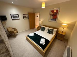 a bedroom with a bed with towels on it at Edmonstone Suite Old Town in Edinburgh