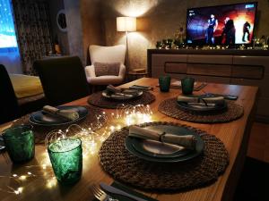 a dining room table with christmas lights on it at Apartment Pamporovo Palaсe A75 in Pamporovo