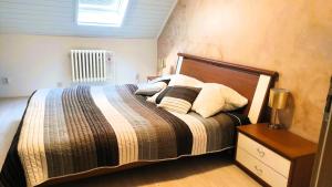 a bedroom with a bed with pillows on it at Blumental apartment, garden, AC in Bratislava