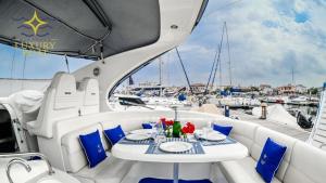 un tavolo su uno yacht con sedie bianche e blu di Sardinia Luxury boat a Portoscuso
