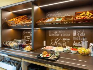 a buffet line with food on display in a restaurant at B&B Hotel Bochum-Herne in Herne