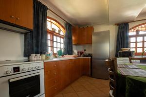 a kitchen with a white stove and a refrigerator at Jacuzzi Pool House AMA5690 in Chalkida