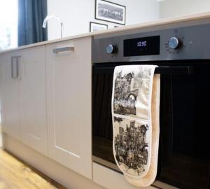 a kitchen with a dish towel hanging on a dishwasher at Lilydale Retreat in Lanchester