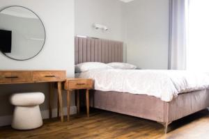 a bedroom with a bed with a desk and a mirror at Central village location in Lanchester