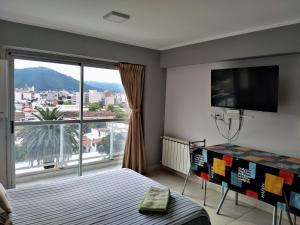 a bedroom with a bed and a large window at Monoambiente turístico la linda de Salta in Salta