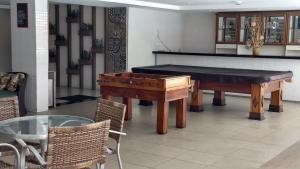 a room with a pool table and a piano at AP 306 flat beira mar praia Tambaú in João Pessoa