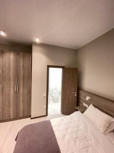 a bedroom with a large bed and wooden cabinets at Seven in Vyshneve