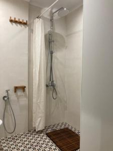a shower with a shower curtain in a bathroom at "Ariane" - Afytos village with sea view in Afitos