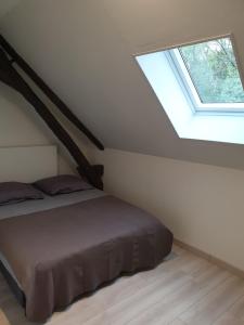 a bedroom with a bed and a window at La Casa D'Augy in Farges-en-Septaine +6 photos