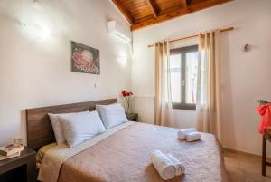 una camera da letto con un letto e due asciugamani di Casa Mavili, Top Location - Cozy Interiors a Rethymno