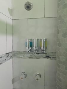 a shower with glass walls and silver fixtures at The Cozy Corner in Nassau +12 photos
