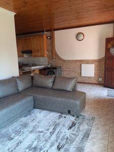 a living room with a couch and a kitchen at The Cottage at 19 in Kempton Park