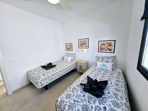 dwa łóżka w pokoju w obiekcie Casa Playa Quemada junto al mar w mieście Playa Quemada
