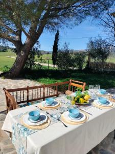 a table with a white table cloth and blue dishes at Casa Celia in Miranda del Rey