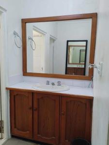 a bathroom with a sink and a mirror at 斐济楠迪机场民宿带空调 in Nadi