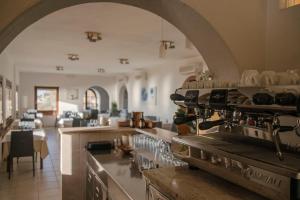 a kitchen with an archway and a counter with glasses at Hotel Villa Rita in Marciana