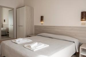 A bed or beds in a room at Hotel Villa Rita