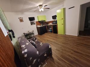 a living room with a couch and a ceiling fan at Warm cozy 1 bdrm close to Hwy in Edmundston +2 photos