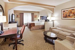 a hotel room with a king bed and a desk at Holiday Inn Hotel & Suites Beaufort at Highway 21, an IHG Hotel in Beaufort
