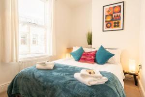 a bedroom with a bed with towels on it at Stylish 3-Bed City Centre Home in Chester by 53 Degrees Property, Ideal for Groups, Private Parking! in Chester
