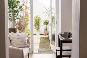 an open door to a patio with potted plants at Stylish 3-Bed City Centre Home in Chester by 53 Degrees Property, Ideal for Groups, Private Parking! in Chester