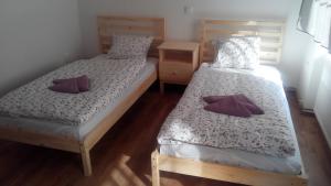 two twin beds in a room with wooden floors at Apartment Zámecká in Děčín
